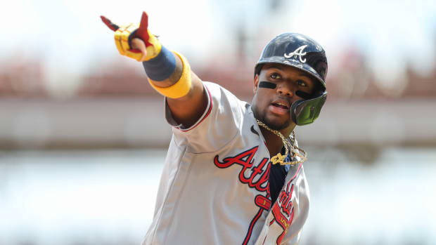 Jun 27, 2021; Cincinnati, Ohio, USA; Atlanta Braves right fielder Ronald Acuna Jr. (13) reacts after hitting a home run against the Cincinnati Reds in the fifth inning at Great American Ball Park.